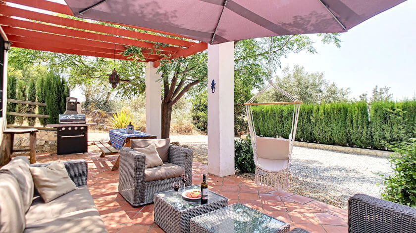 Terrace with seating area under shade with barbecue area